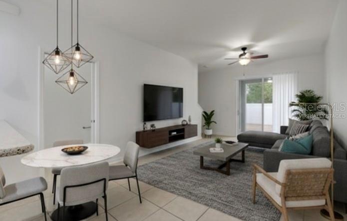 9161 Shepton Street Orlando, FL 32825 - Photo 14 of 62 a living room with furniture a chandelier and a flat screen tv