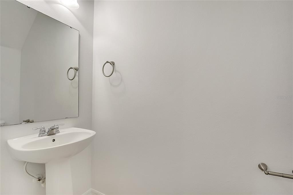 9161 Shepton Street Orlando, FL 32825 - Photo 16 of 62 a bathroom with a sink and mirror