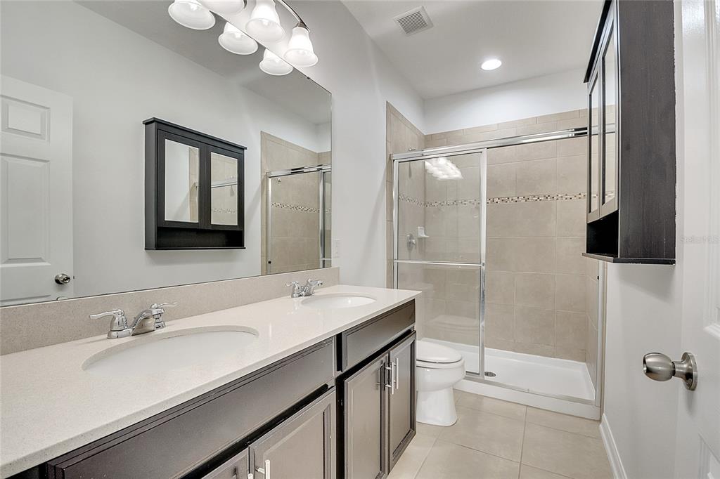 9161 Shepton Street Orlando, FL 32825 - Photo 28 of 62 a bathroom with a sink a toilet and shower