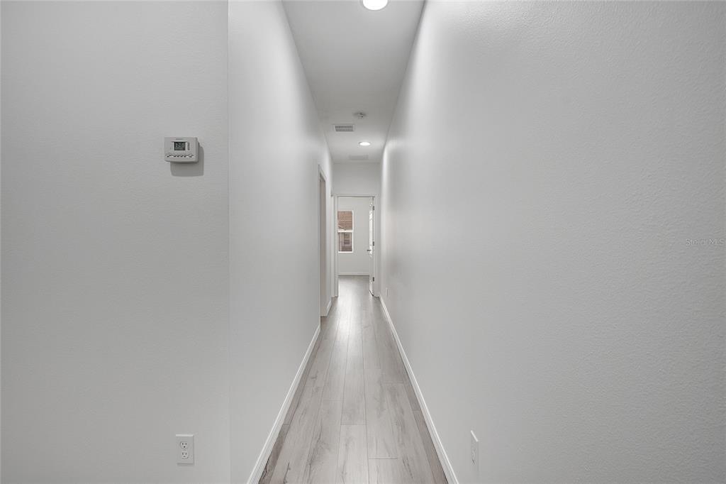 9161 Shepton Street Orlando, FL 32825 - Photo 32 of 62 a view of a hallway with wooden floor