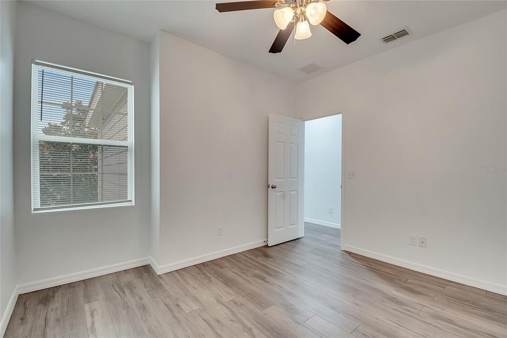 9161 Shepton Street Orlando, FL 32825 - Photo 35 of 62 a view of an empty room with wooden floor and a window