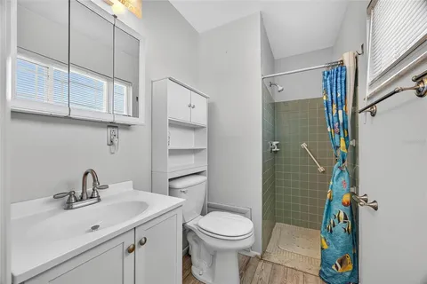 a bathroom with a sink toilet and shower