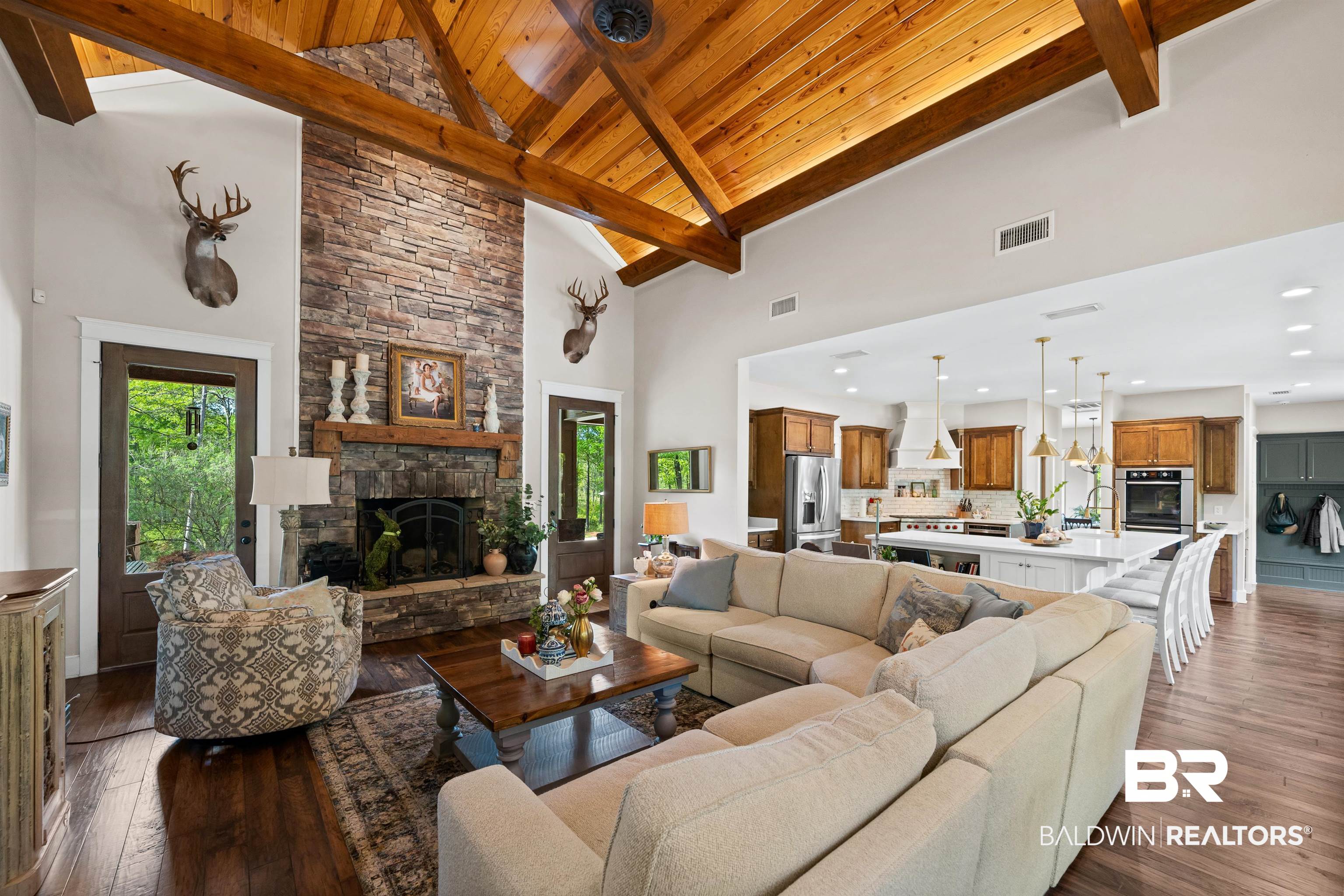 47252 Emmons Road Bay Minette, AL 36507 - Photo 10 of 50 Living room with dark wood finished floors, a stone fireplace, and a high wood beamed ceiling