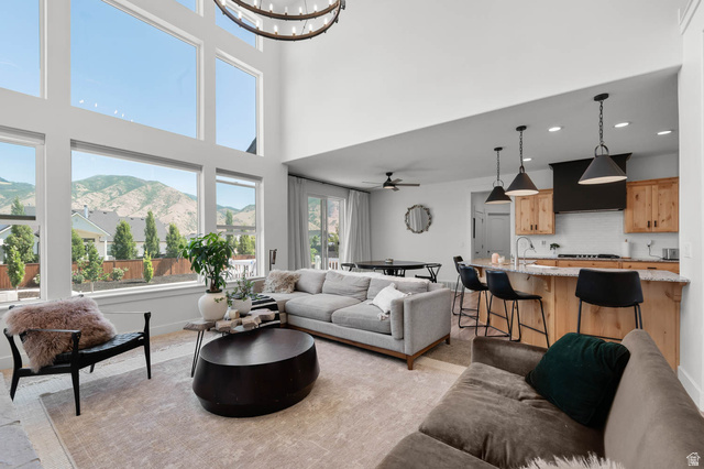 500 North 516th Street West, Unit 19 Mapleton, UT 84664 - Photo 5 of 41 Vaulted living area featuring high ceilings, a prominent chandelier, and an expansive wall of windows
