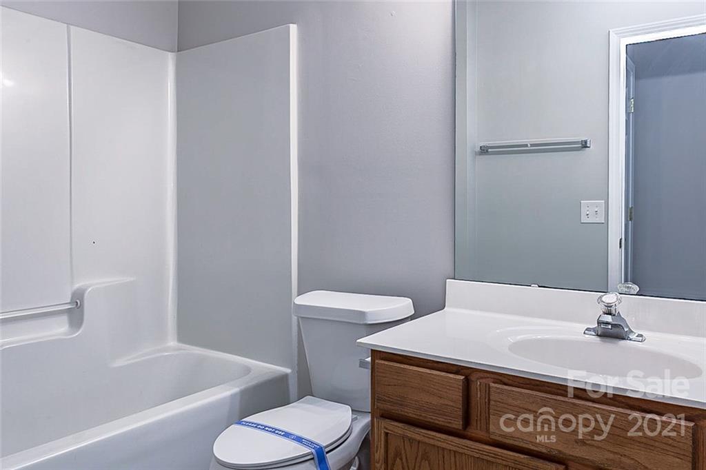 1216 Winding Path Road Clover, SC 29710 - Photo 6 of 15 a bathroom with a granite countertop sink toilet and shower
