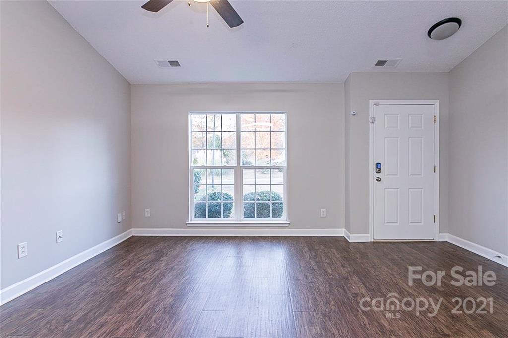 1216 Winding Path Road Clover, SC 29710 - Photo 9 of 15 an empty room with wooden floor and windows