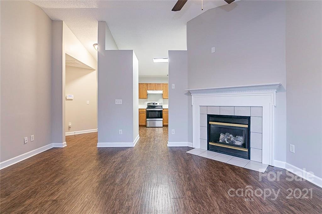 1216 Winding Path Road Clover, SC 29710 - Photo 10 of 15 a view of an empty room with wooden floor fireplace and a window