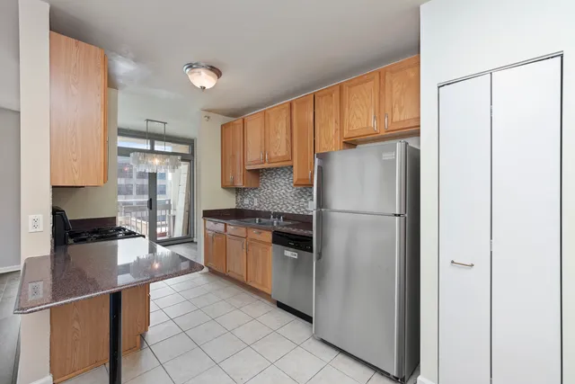 a kitchen with stainless steel appliances a refrigerator sink and cabinets