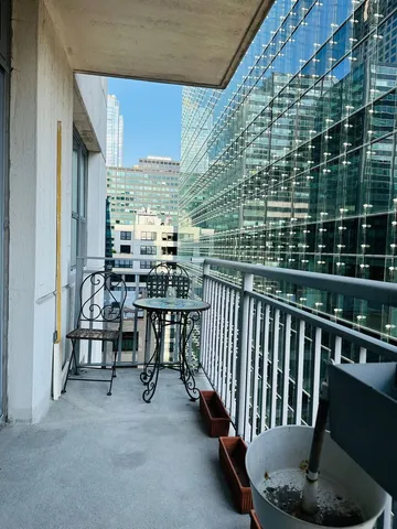 a view of a chairs and table in the balcony