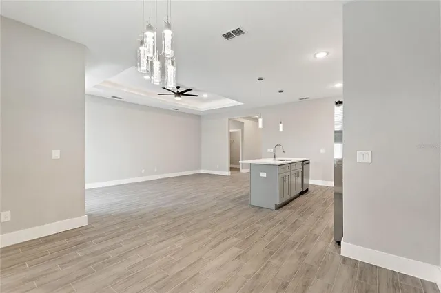 a view of a room with wooden floor and chandelier