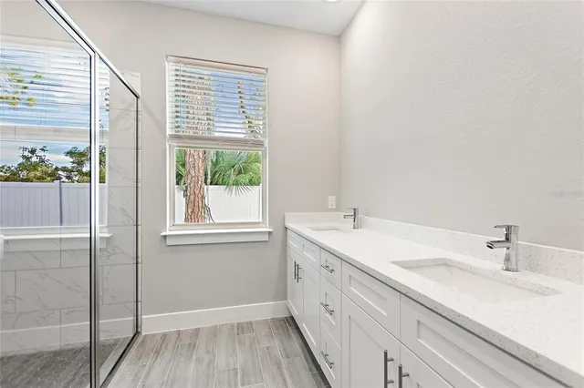 a bathroom with a double vanity sink and mirror