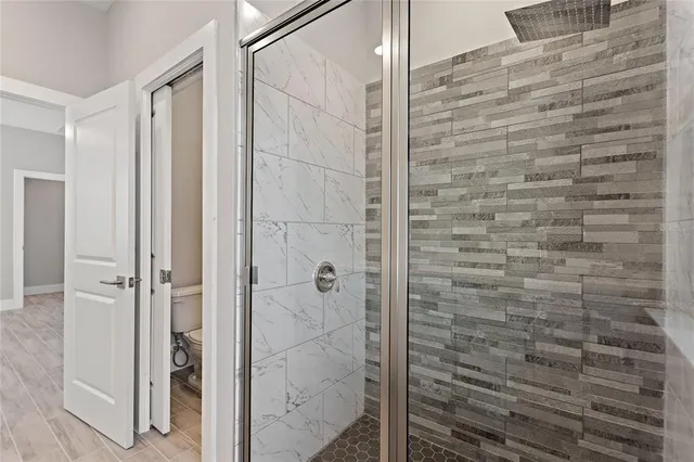 a bathroom with a shower and a glass door