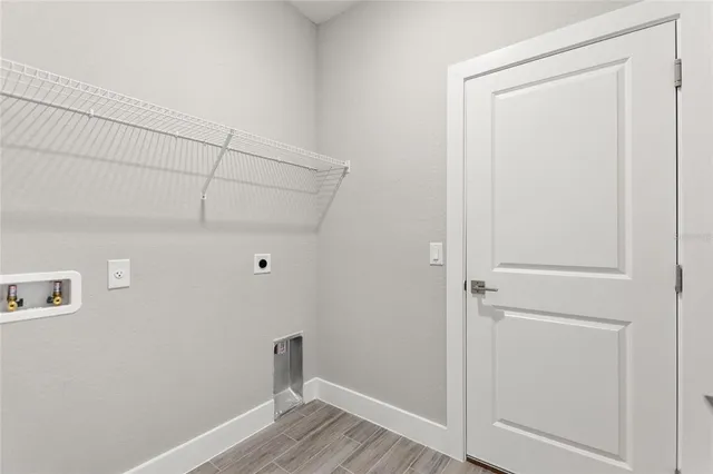 a view of a room with wooden floor