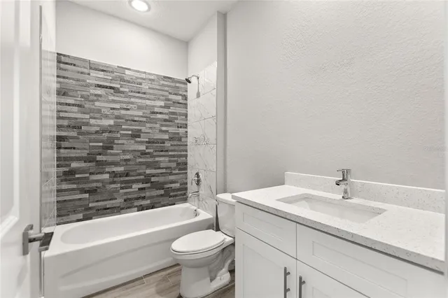 a bathroom with a sink a toilet and bathtub