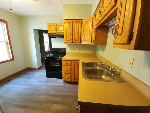 a kitchen with a sink a stove and refrigerator