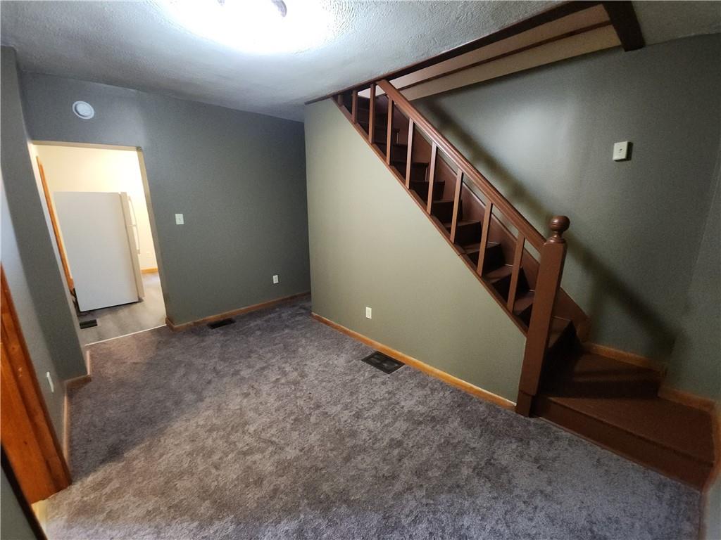 8 Elm Street Bessemer, PA 16112 - Photo 14 of 22 a view of an empty room with stairs