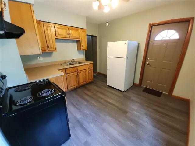 a kitchen with a refrigerator and a stove
