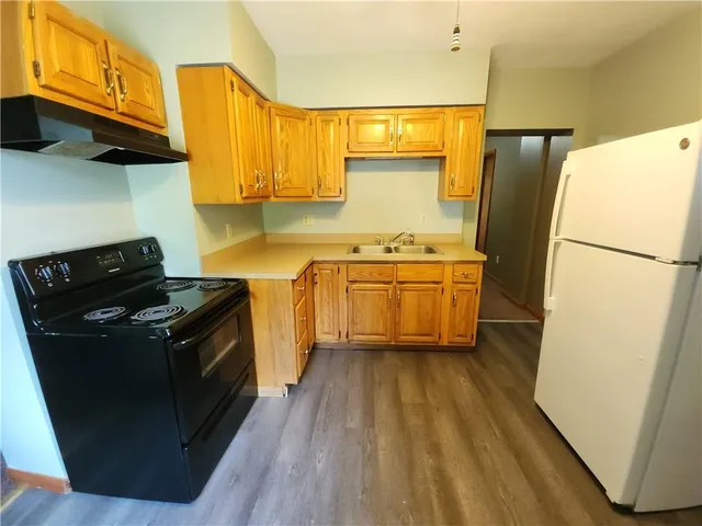 a kitchen with a sink a refrigerator and a stove
