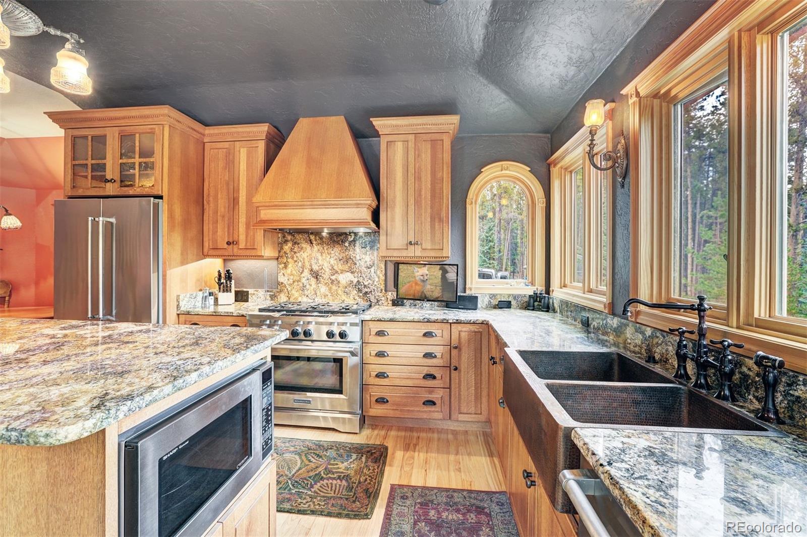 644 Spruce Creek Road Breckenridge, CO 80424 - Photo 13 of 42 a large kitchen with stainless steel appliances granite countertop a stove a sink and a refrigerator