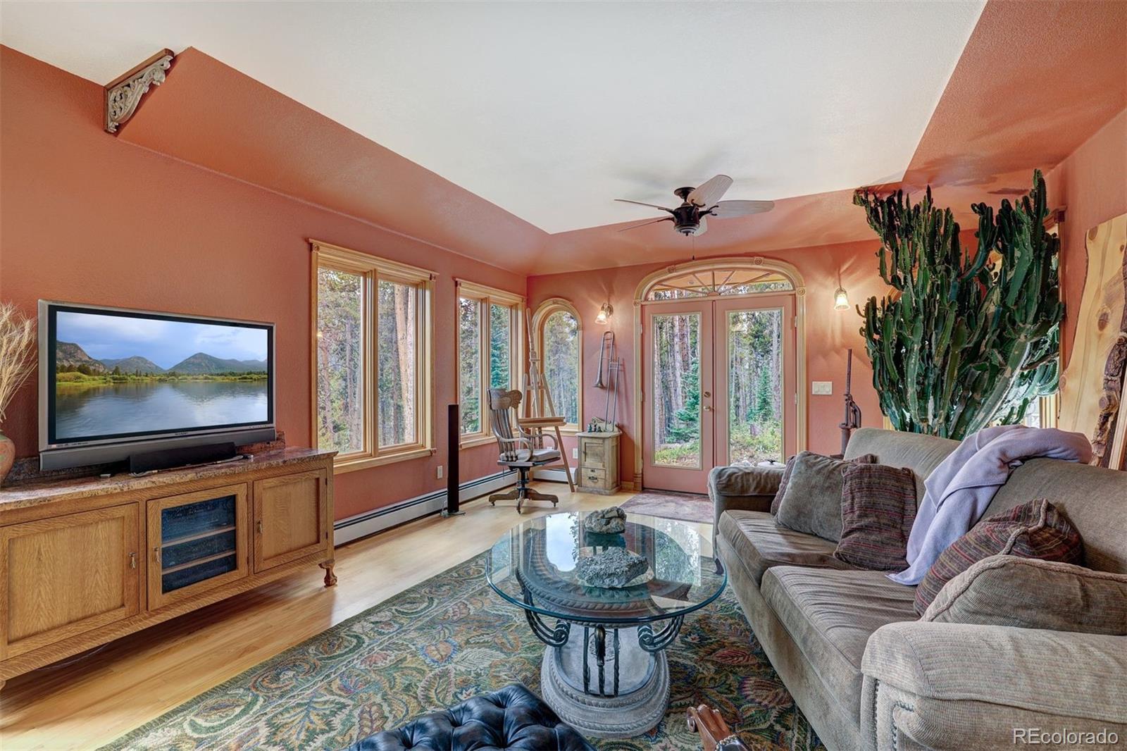 644 Spruce Creek Road Breckenridge, CO 80424 - Photo 16 of 42 a living room with furniture a flat screen tv and a floor to ceiling window