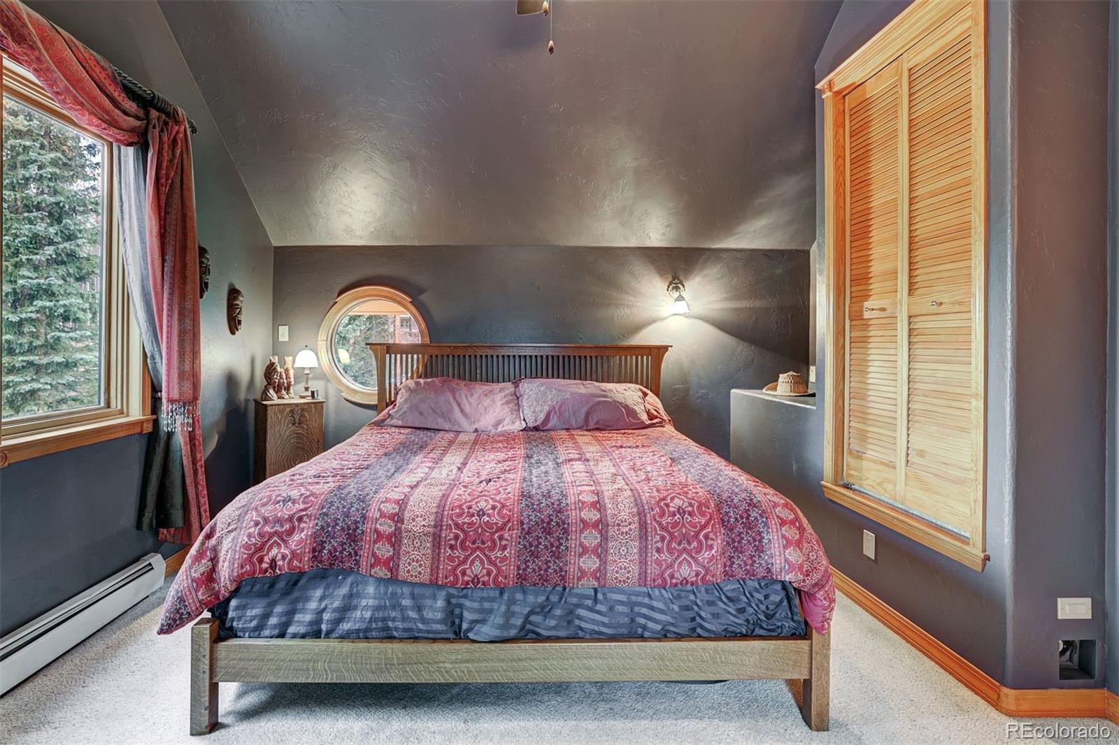 644 Spruce Creek Road Breckenridge, CO 80424 - Photo 24 of 42 a bedroom with a large bed and a large window