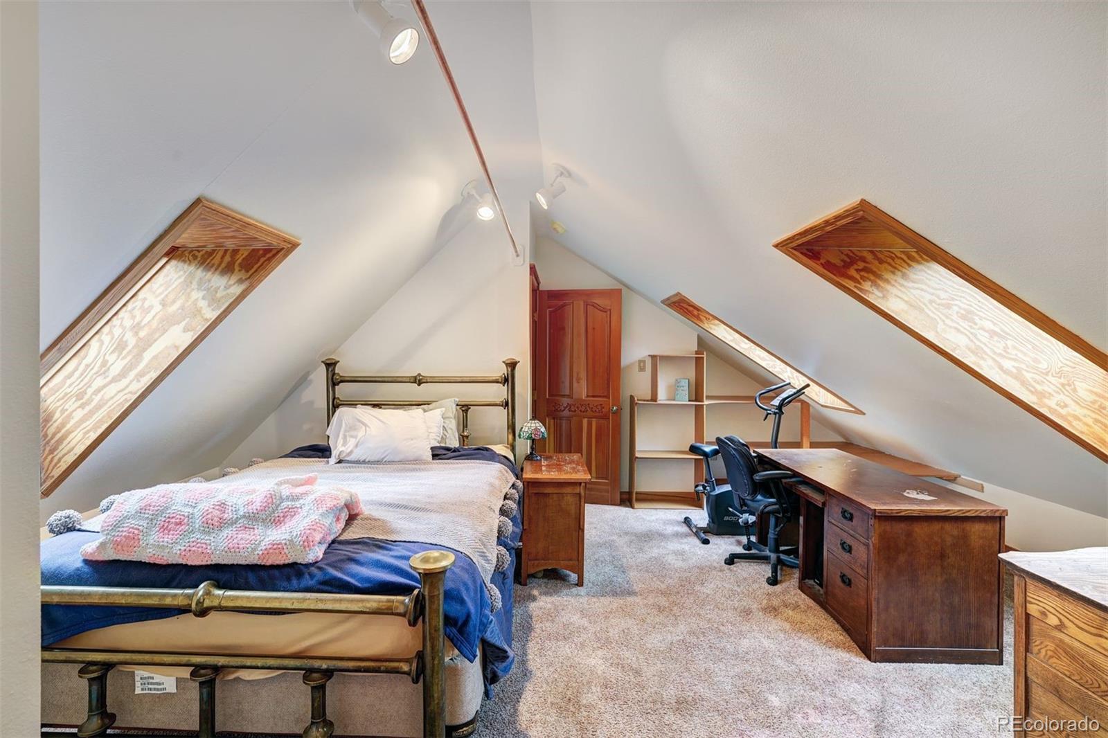 644 Spruce Creek Road Breckenridge, CO 80424 - Photo 27 of 42 a bedroom with a bed and a window