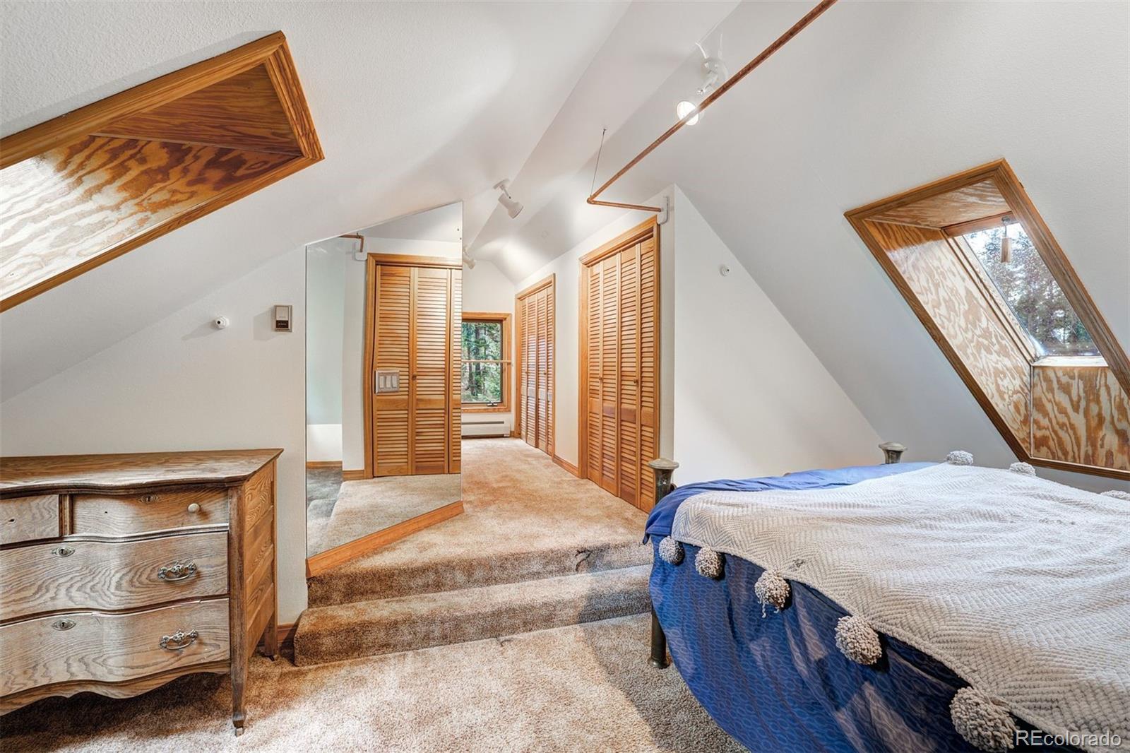 644 Spruce Creek Road Breckenridge, CO 80424 - Photo 28 of 42 a spacious bedroom with a bed and a dresser