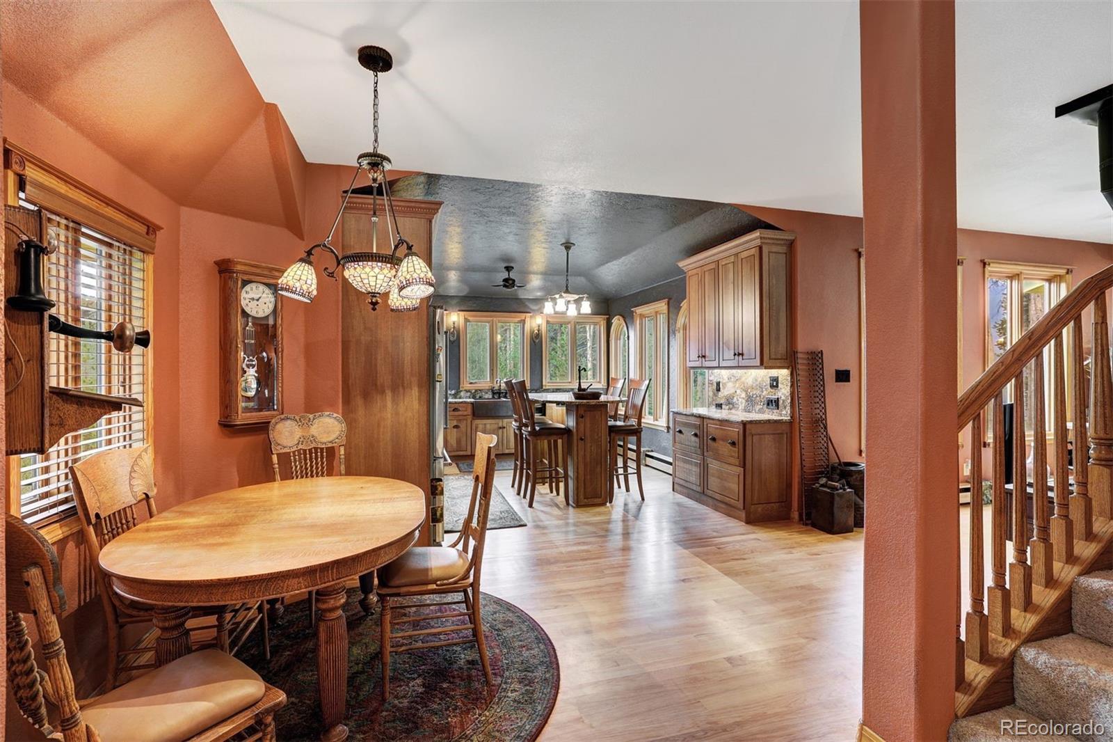 644 Spruce Creek Road Breckenridge, CO 80424 - Photo 8 of 42 a dining room with furniture a chandelier and wooden floor