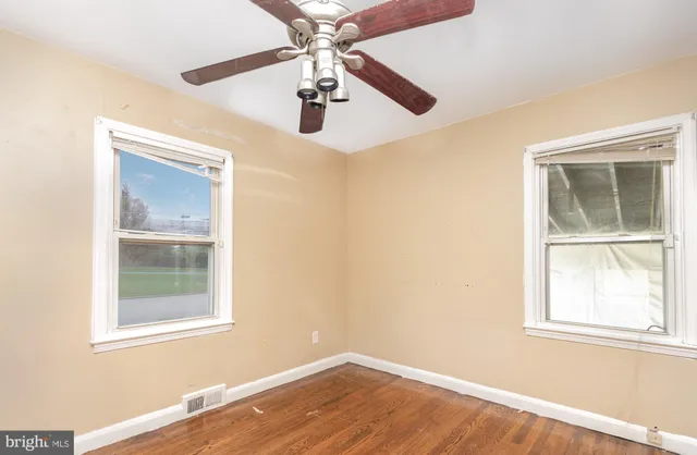 a view of room with hardwood floor and window