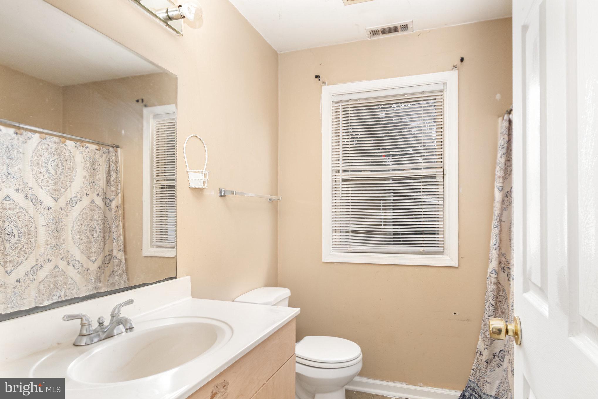 25 Mitchell Avenue Aberdeen, MD 21001 - Photo 14 of 26 a bathroom with a sink toilet a mirror and shower