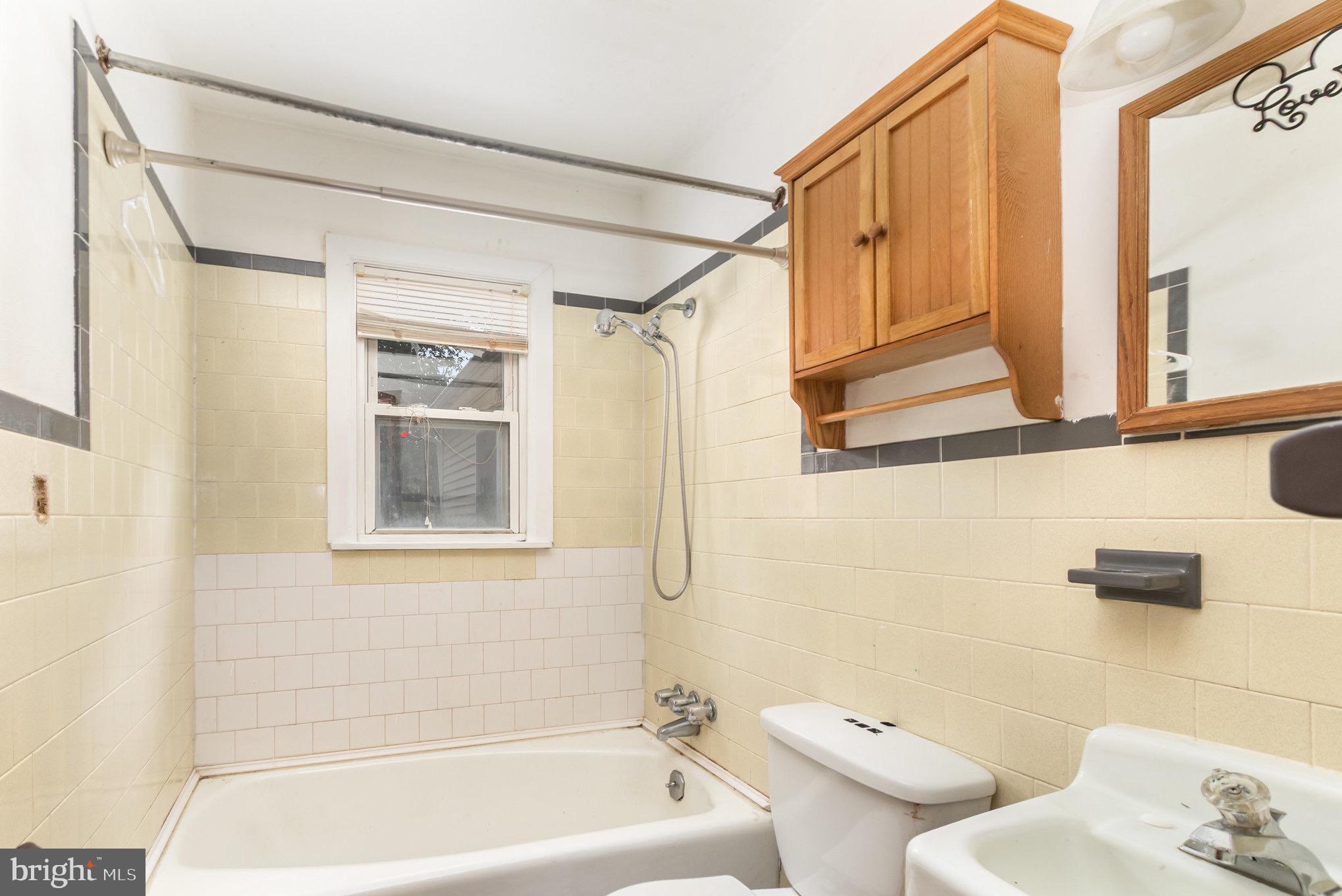 25 Mitchell Avenue Aberdeen, MD 21001 - Photo 18 of 26 a bathroom with a bathtub a window and a shower