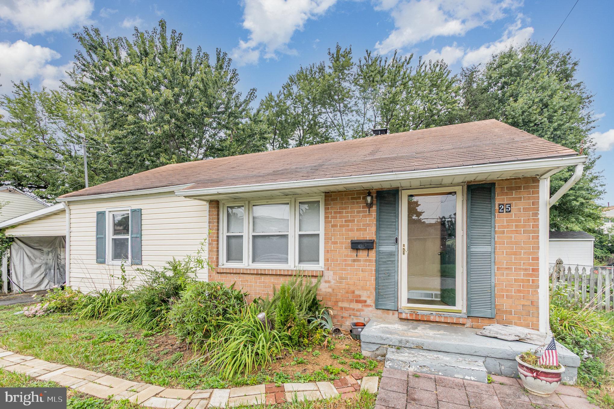 25 Mitchell Avenue Aberdeen, MD 21001 - Photo 6 of 26 a view of a white house with a large windows and flower plants