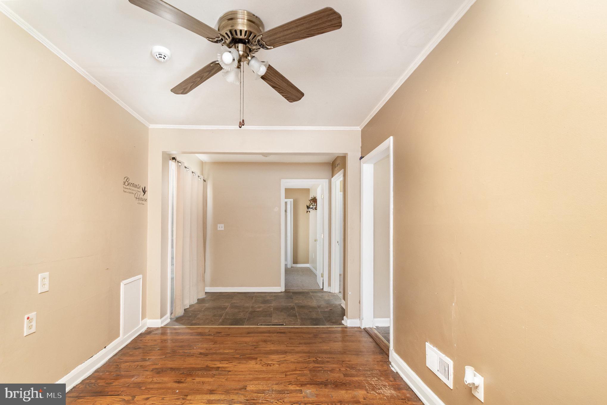 25 Mitchell Avenue Aberdeen, MD 21001 - Photo 7 of 26 a view of a hallway with a chandelier fan and wooden floor