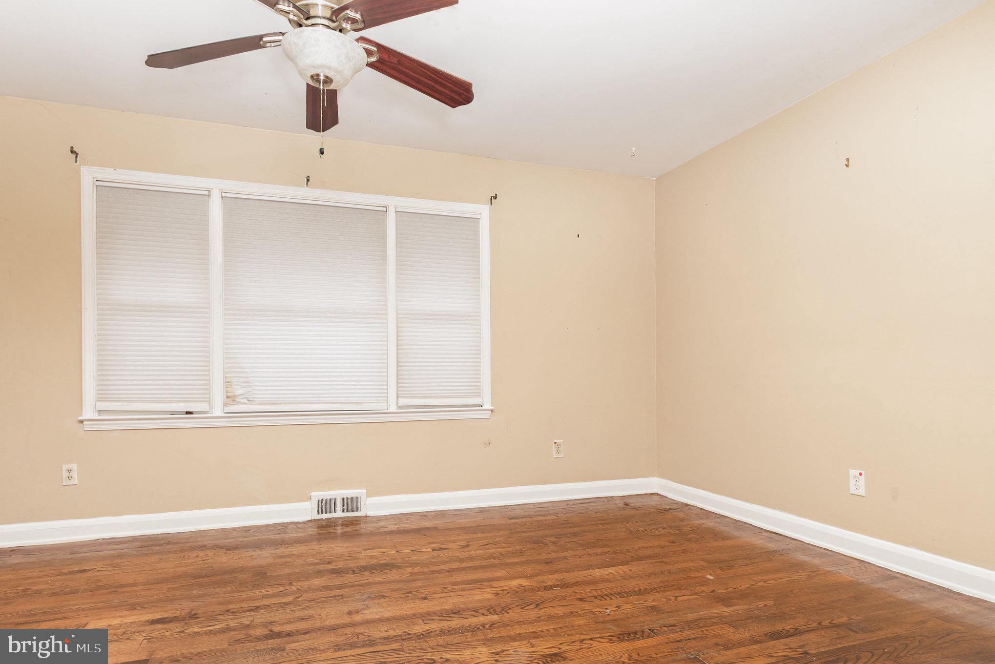 25 Mitchell Avenue Aberdeen, MD 21001 - Photo 9 of 26 an empty room with wooden floor fan and windows