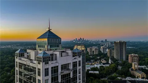 a view of a balcony with wooden floor and city view