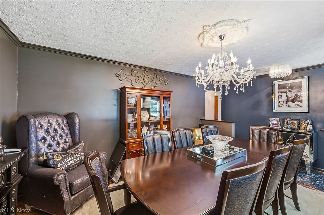 6890 Refugee Road Pickerington, OH 43147 - Photo 9 of 49 Formal dining space featuring dark gray walls and a textured white ceiling