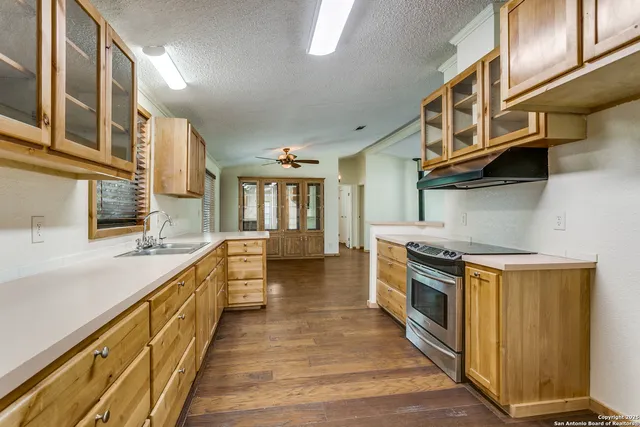 a kitchen with stainless steel appliances granite countertop a stove and a sink