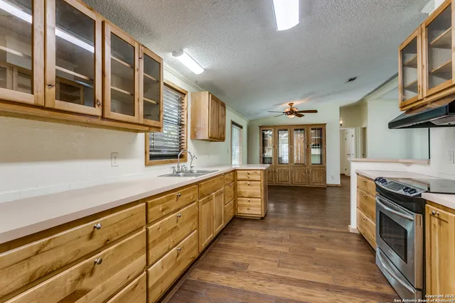 a kitchen with stainless steel appliances granite countertop a stove and a sink