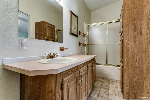 a bathroom with a sink and a mirror
