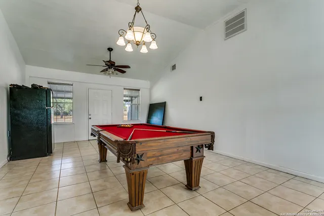 a dining room with furniture and chandelier