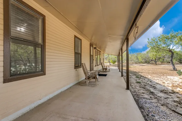 a view of a patio with a table and chairs