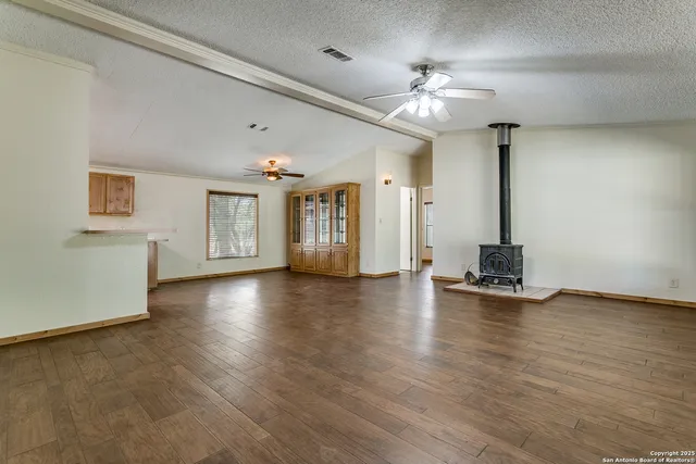 a view of a livingroom with hardwood floor and a ceiling fan