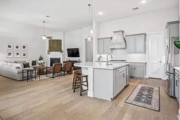 a kitchen that has a lot of cabinets a sink and a stove in it
