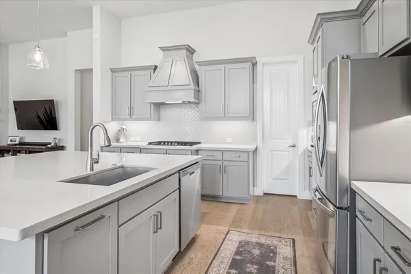 a kitchen with a sink appliances and cabinets