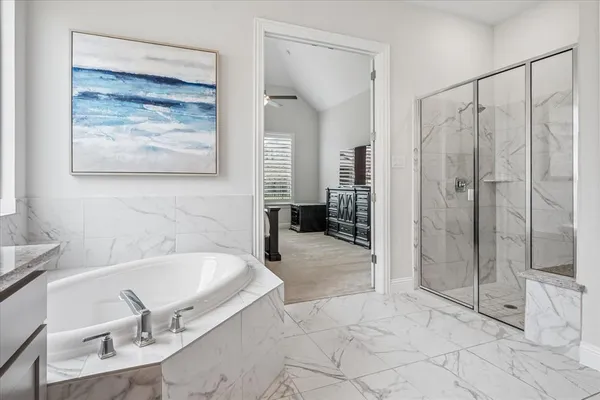 a bathroom with a tub and shower