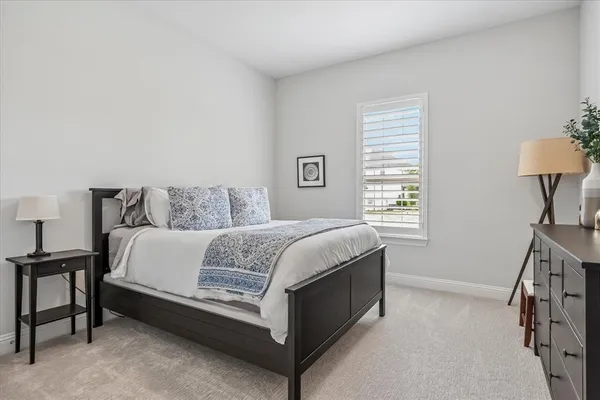 a bedroom with a bed and a lamp on table