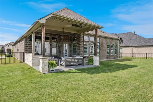 a view of a house with a yard and sitting area