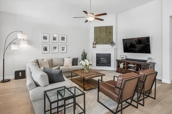 a living room with furniture a fireplace and a flat screen tv