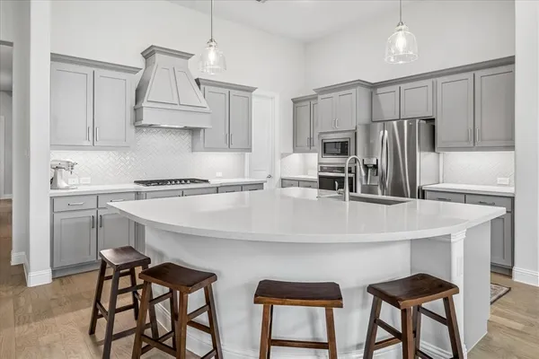 a kitchen with stainless steel appliances a sink and a refrigerator