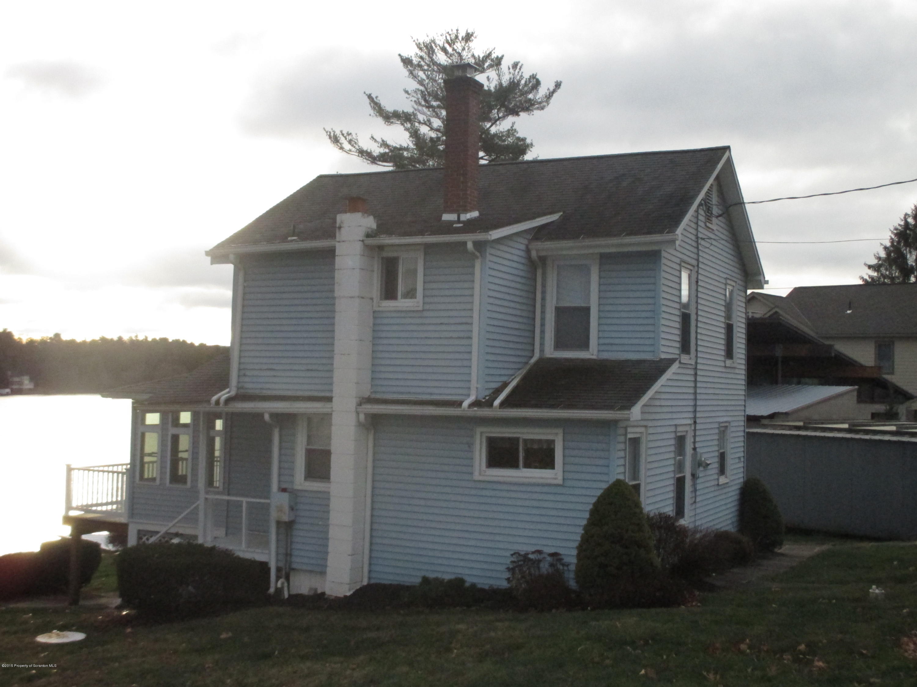 394 Point Road Lake Winola, PA 18419 - Photo 2 of 28 a front view of a house with a yard